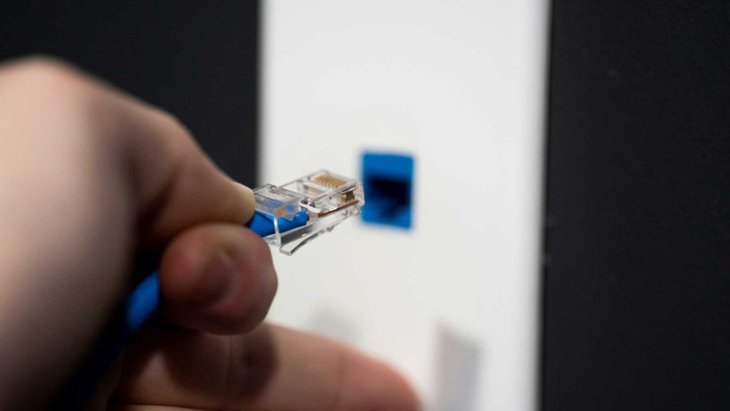 Mano conectando cable ethernet
